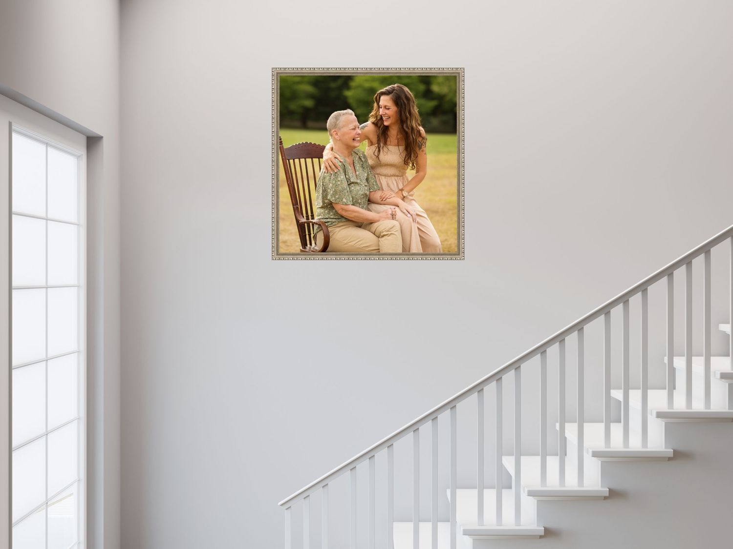 A person walks beside a modern staircase with a white railing in an airy, light-filled residential interior space.