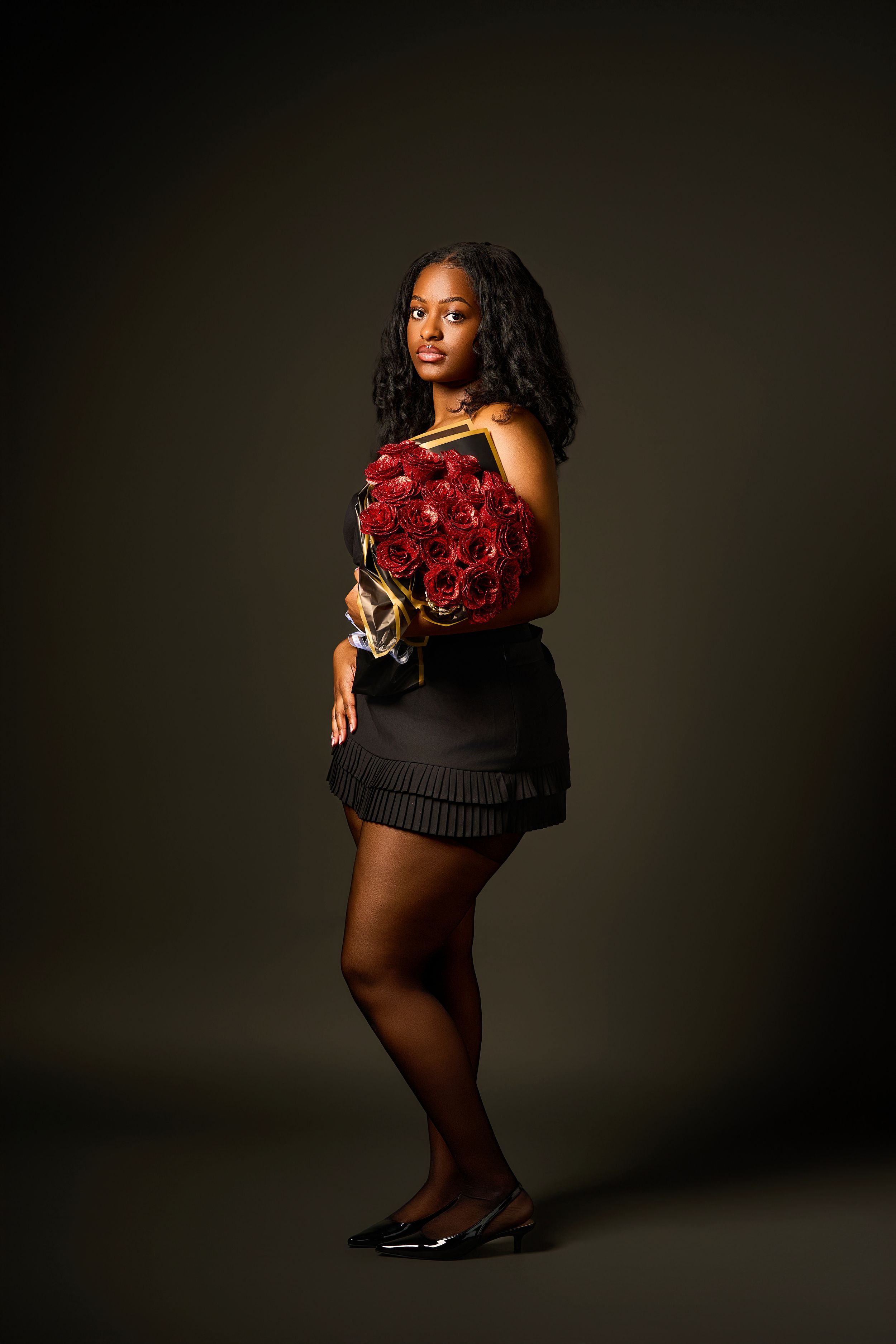 Artistic portrait series featuring red roses in moody dark lighting.