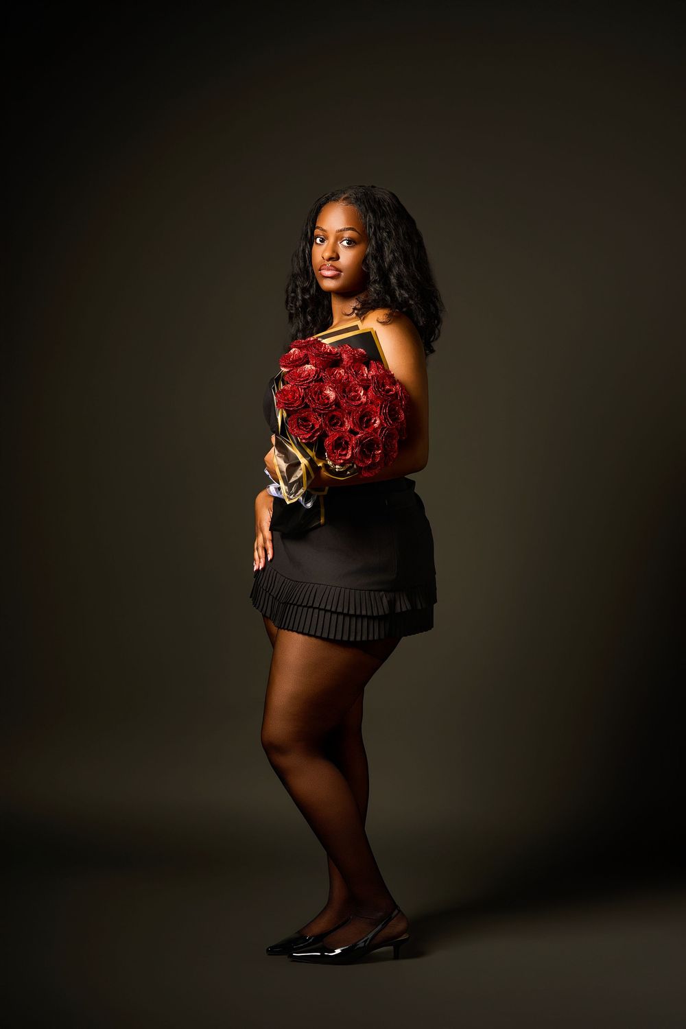 Artistic portrait series featuring red roses in moody dark lighting.