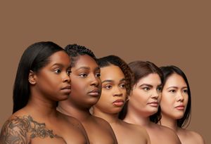 Five women with diverse skin tones and natural beauty poses against brown backdrop in side profile view.