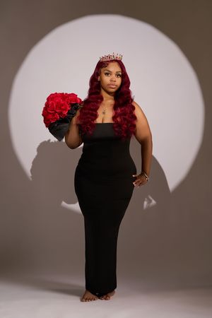 A series of editorial fashion poses in a black dress against a gray studio backdrop with dramatic lighting.
