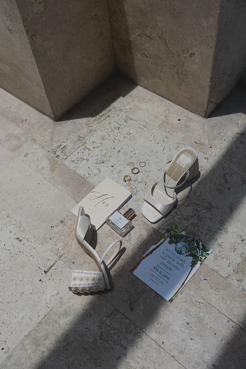 Elegant bridal shoes and wedding invitation at Fairmont Mayakoba Riviera Maya wedding photographer.