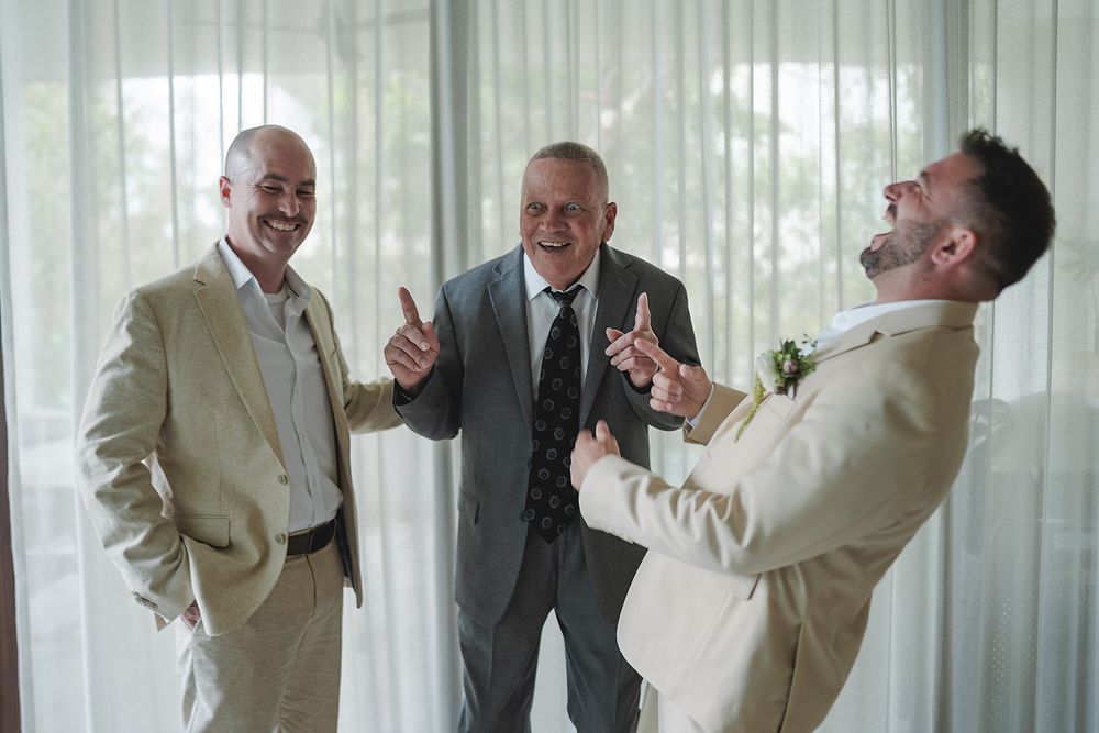 Groom laughing with groomsmen before wedding at Fairmont Mayakoba Riviera Maya photography.