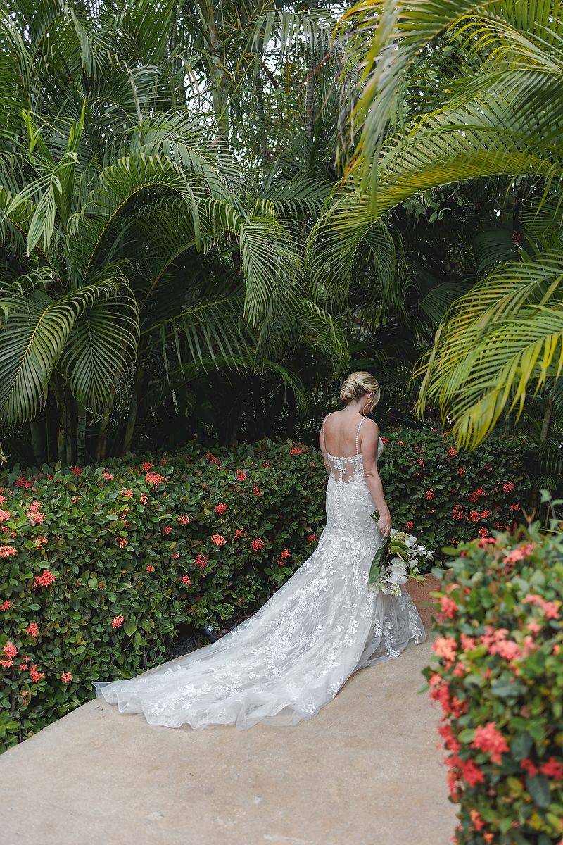 Bride in lace gown on tropical path at Fairmont Mayakoba Riviera Maya wedding photographer.