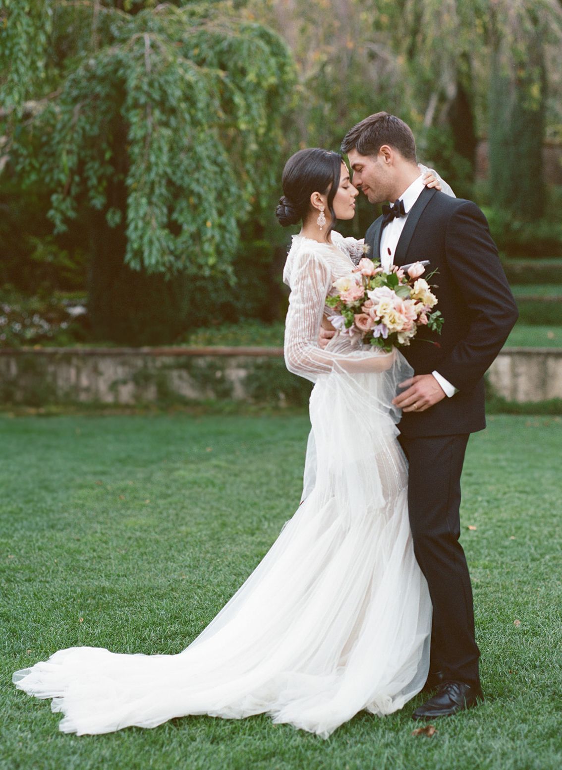 Black and white photo series showing back details of a princess wedding gown at an elegant reception table setting.