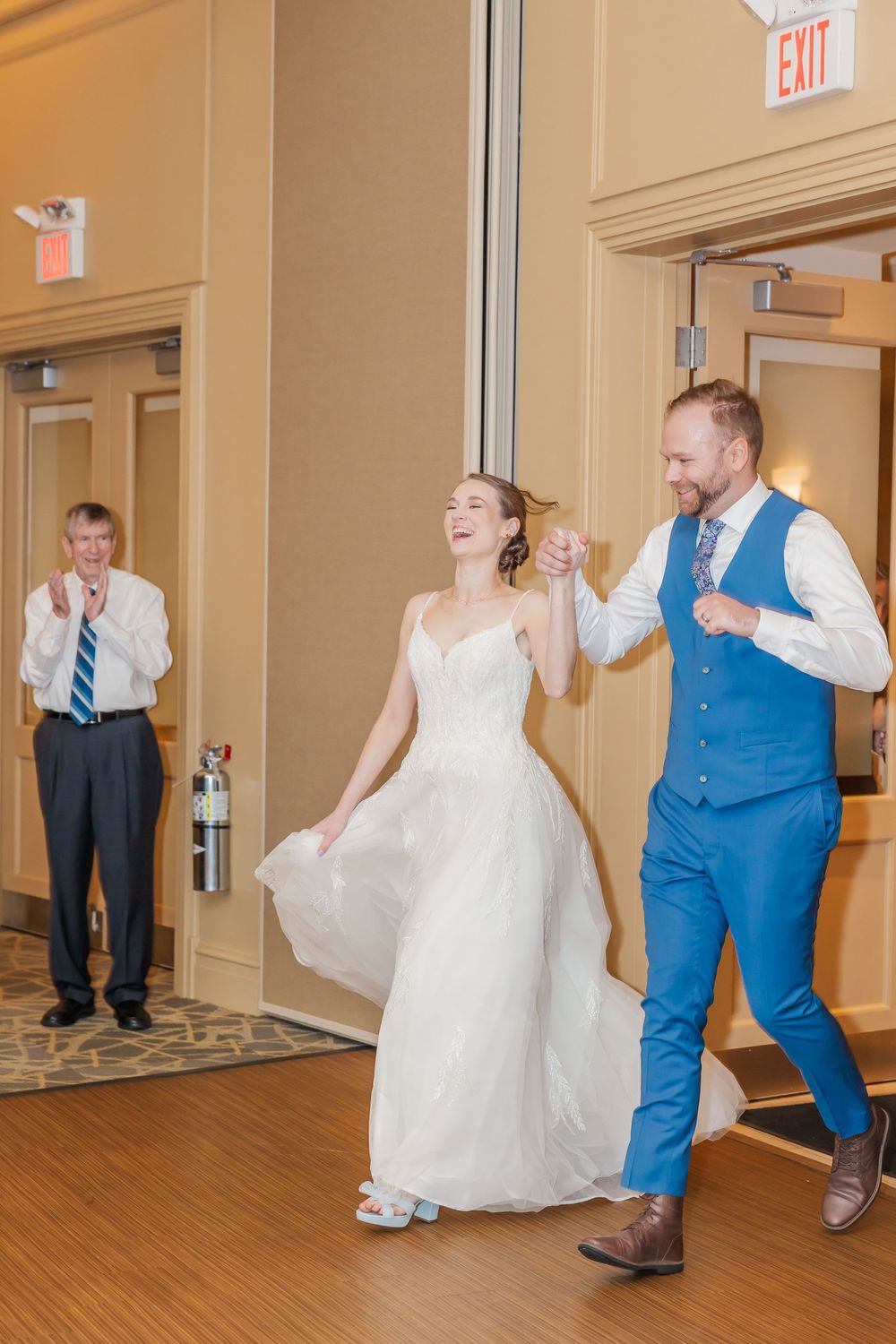 Guests at a wedding reception dance playfully in a series of candid shots showing movement and joy in a hotel hallway.