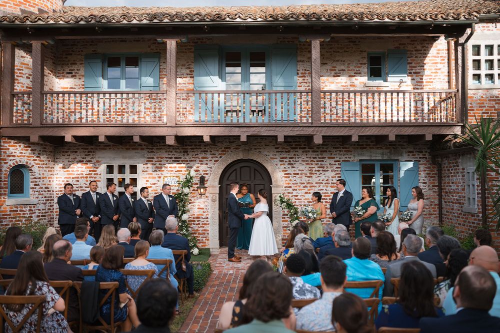 Outdoor wedding ceremony at Casa Feliz historic venue with brick walls and Spanish colonial architecture in Winter Park Florida.
