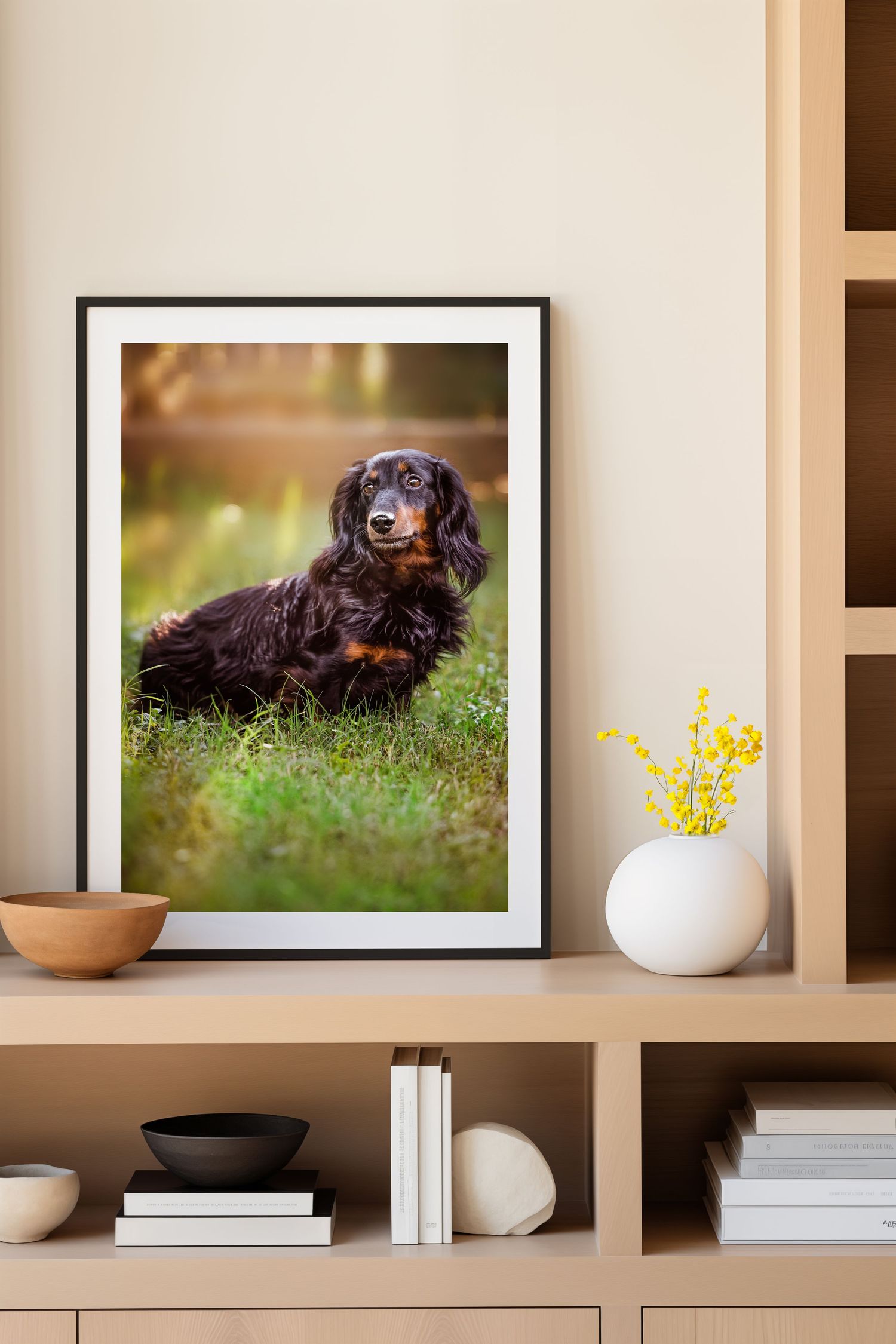 Framed portrait of family dog displayed on wooden shelving unit with and minimalist home decor items in Keller, TX