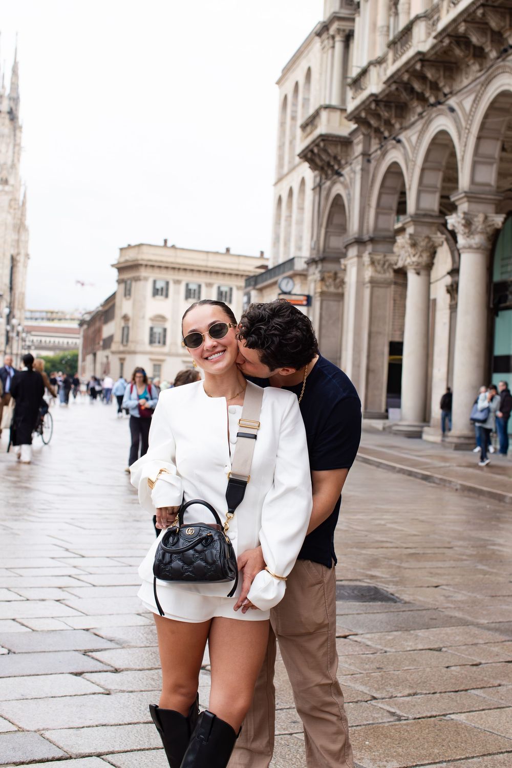 Couple laughing and looking at each other in Milan, Italy. Couple's engagement portraits by Faith's Flicks- Faith Rodriguez.