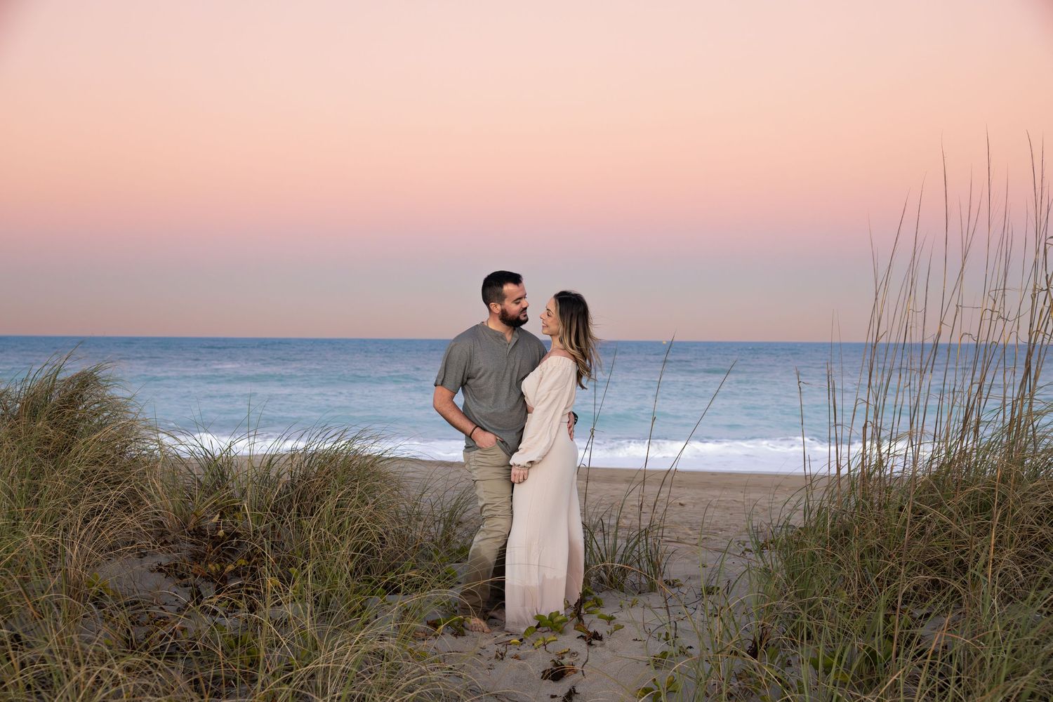 Romantic beach couples portrait at sunset on Hutchinson Island in Fort Pierce Florida between coastal dunes with ocean views