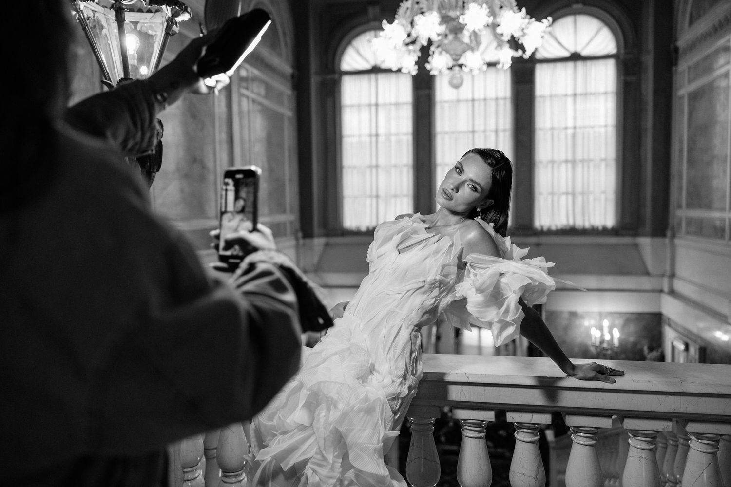 A black and white photo sequence showing a couple dancing and spinning in an elegant ballroom setting.