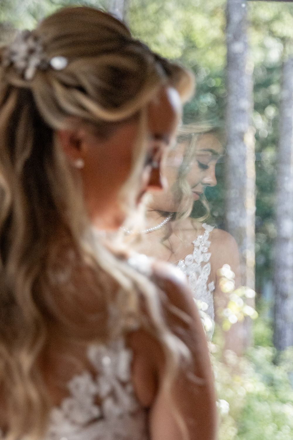 Soft focus portrait through trees with natural sunlight filtering through branches.