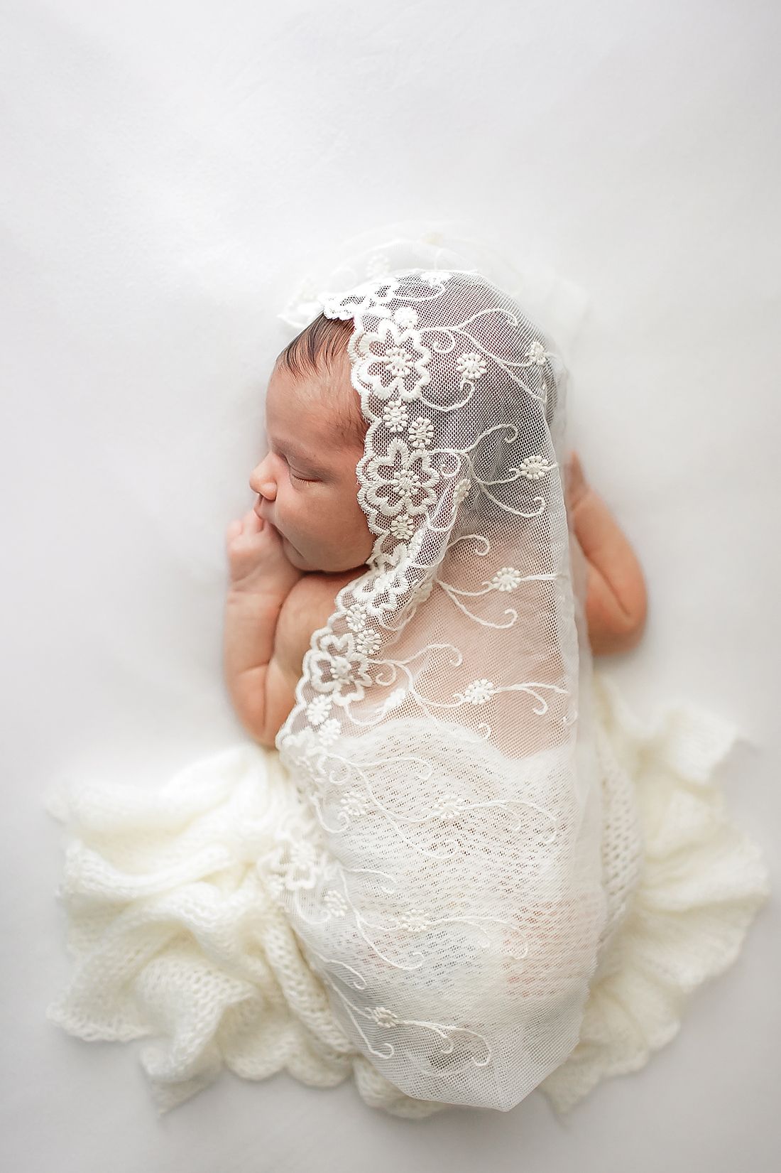 Peaceful sleeping baby on white blanket – timeless newborn photography Springfield MO.