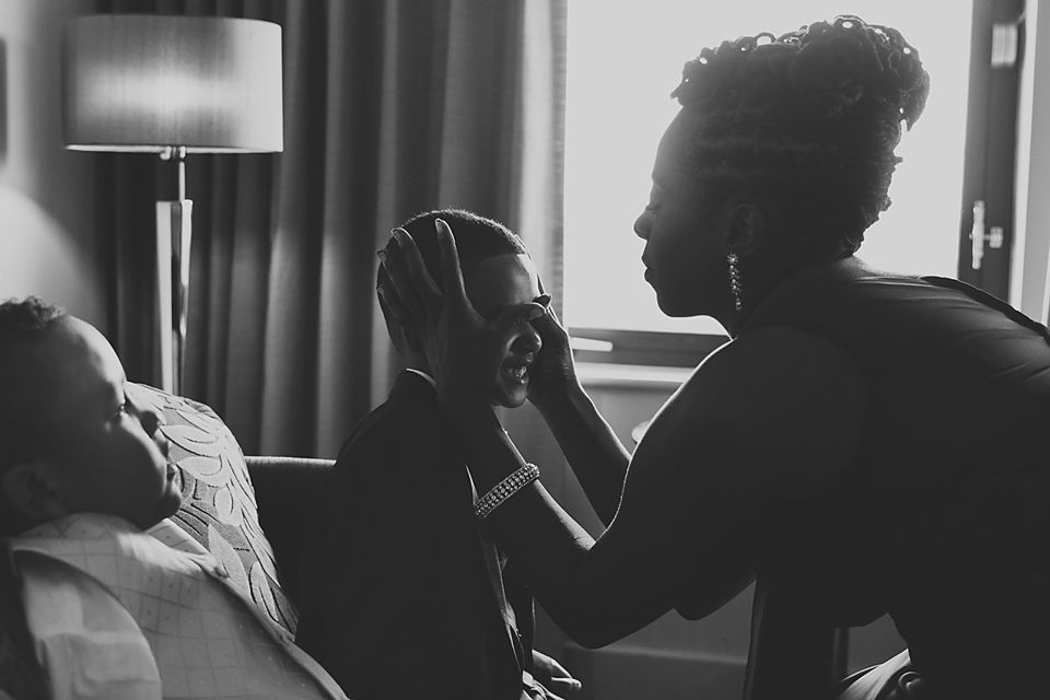 Wedding party members sharing laughter and intimate moments in black and white photography.