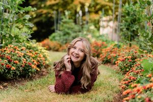 Outdoor photo series showing someone lying in grass near vibrant orange flowers on a sunny autumn day.