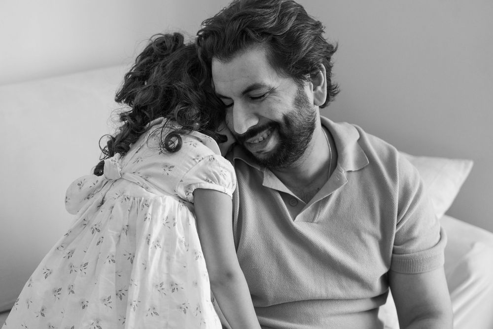 A series of black and white photographs showing intimate moments of laughter and joy between two people.