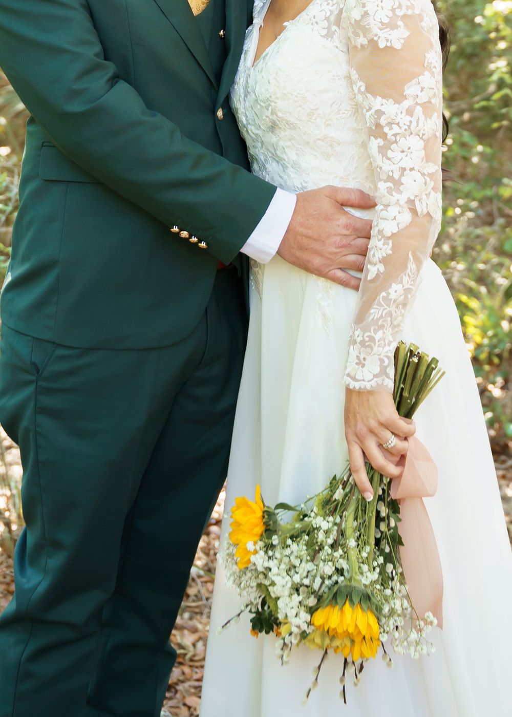 A series of wedding photos showing close-up details of a white lace dress against a dark green suit with sunflowers.