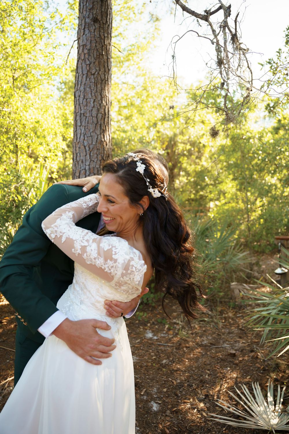 A sequence of romantic embraces between a couple in a forest setting with golden sunlight filtering through trees.