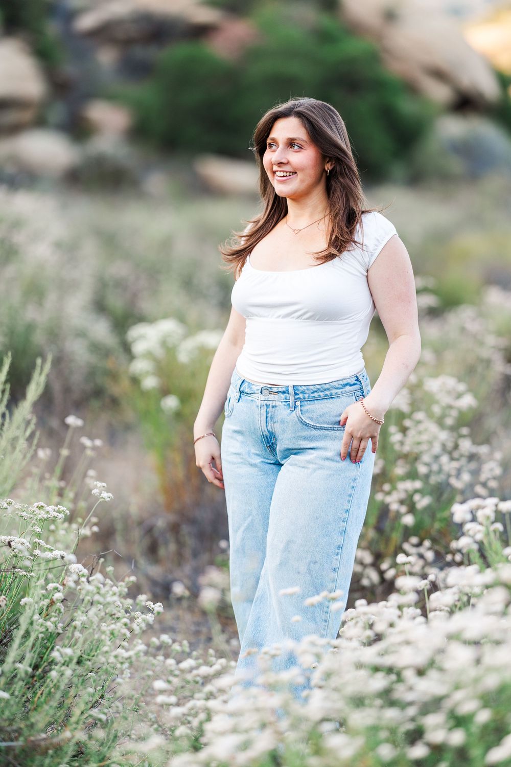 Simi Valley high school graduate posing at Corriganville Park with scenic trails and natural light for outdoor graduation portraits.