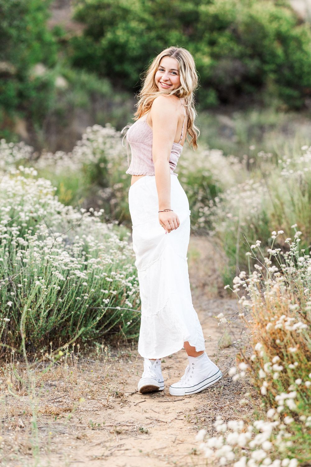 Simi Valley high school graduate posing at Corriganville Park with scenic trails and natural light for outdoor graduation portraits.