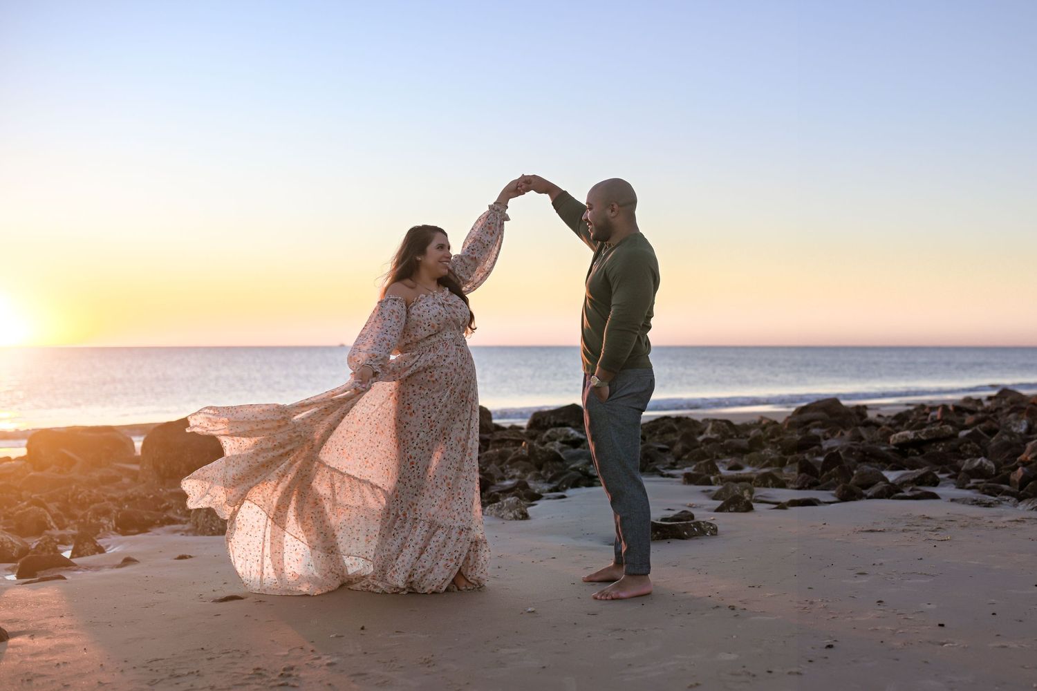 A couple dancing on a beach at sunrise for a photo session in Jekyll Island with Grit and Grace Photography