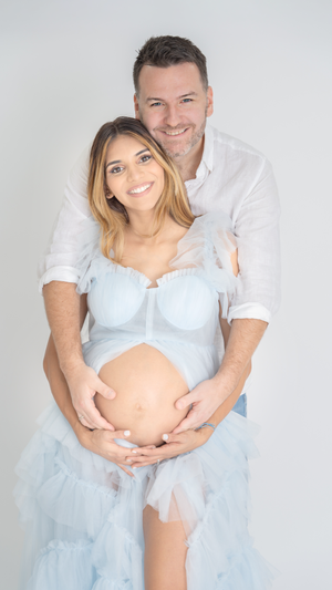 Sweet maternity portraits showcasing baby bump with light blue tulle dress.