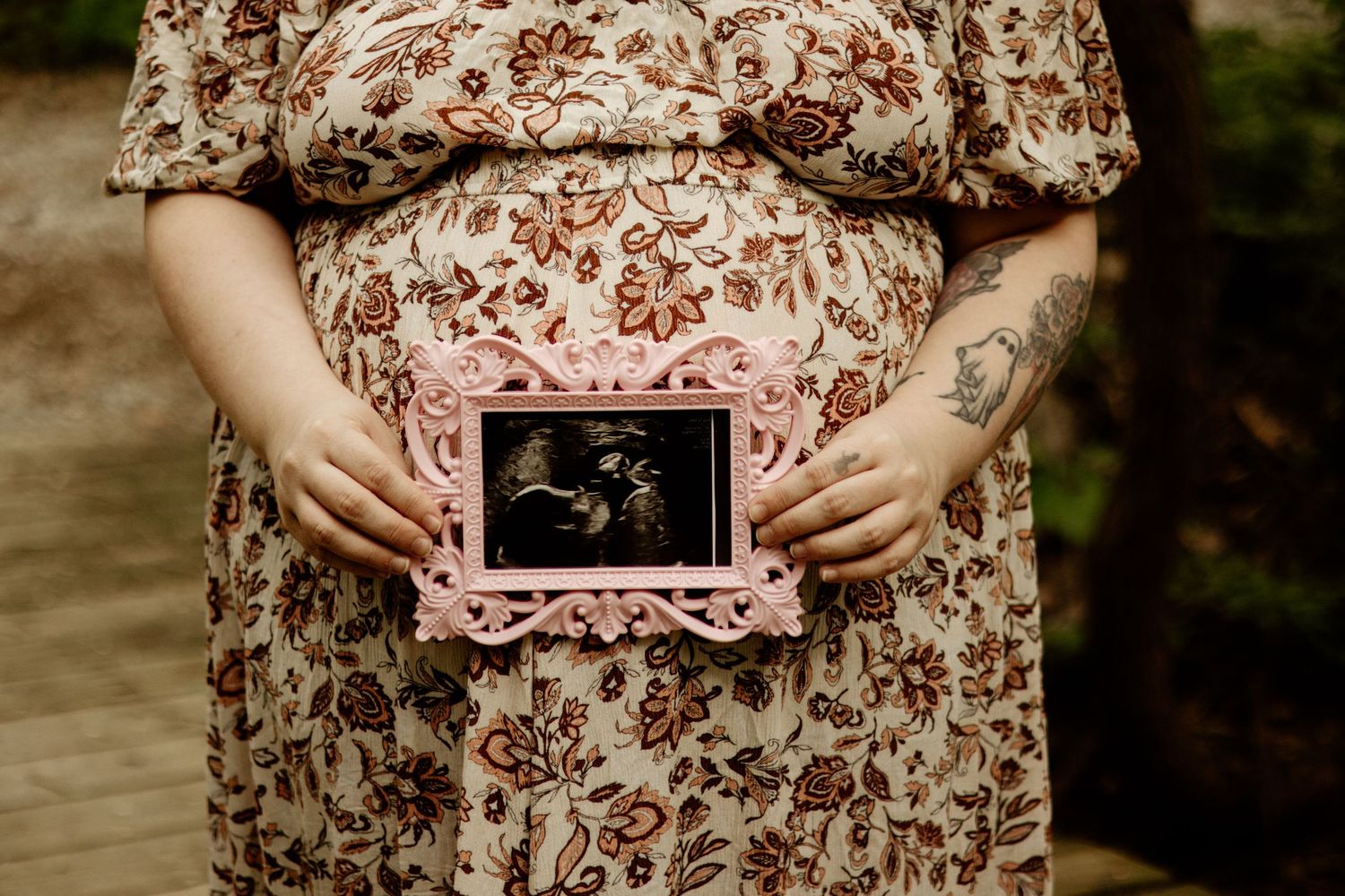 expecting mom holding ultrasound pic