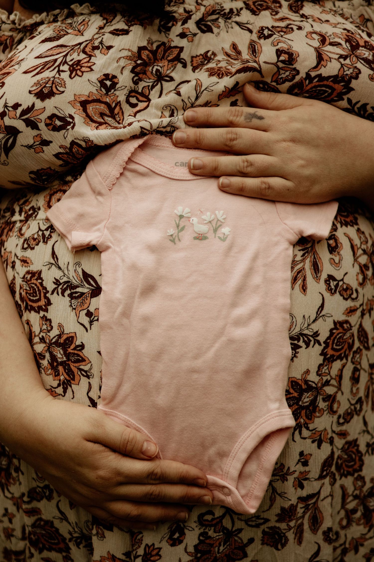 baby clothing on pregnant mom's belly