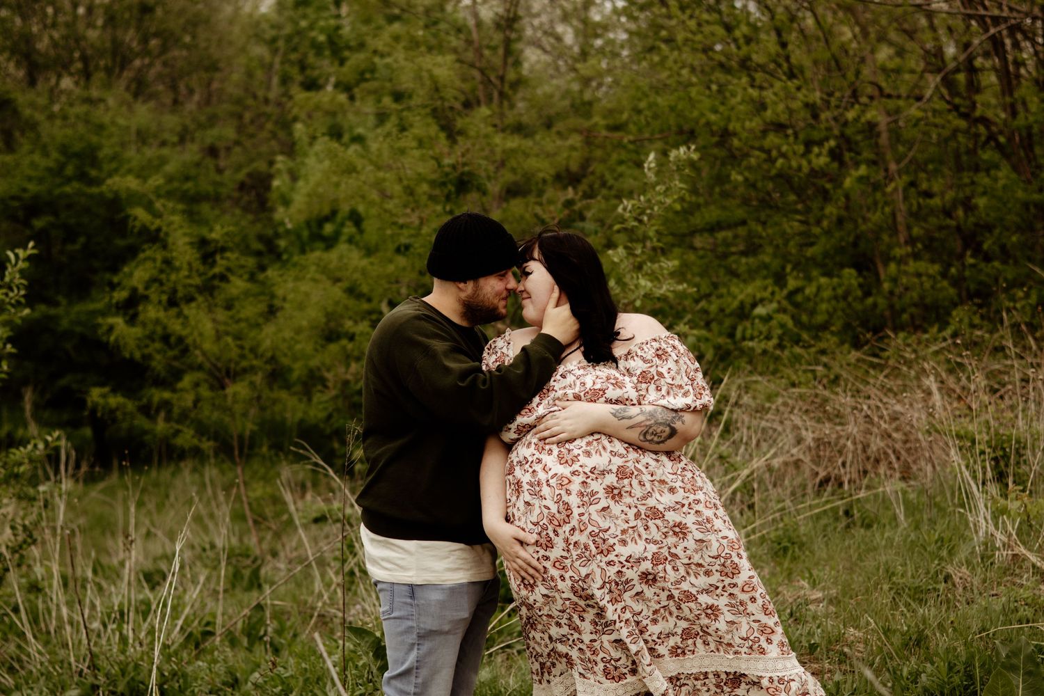 expecting couple embracing
