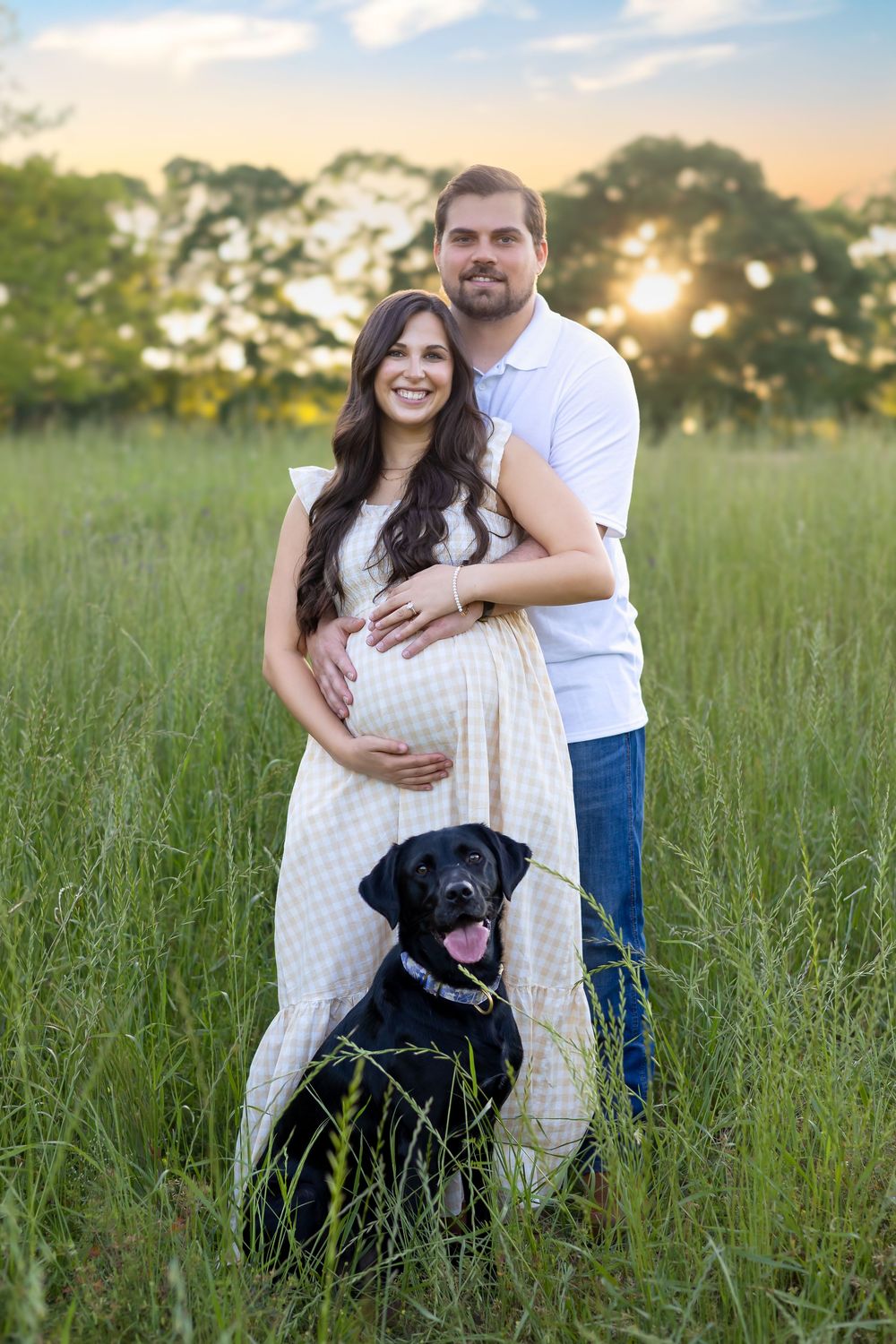 Expecting couple standing in tall grass at sunset with black lab in Watkinsville near Athens GA - family, maternity & newborn photographer