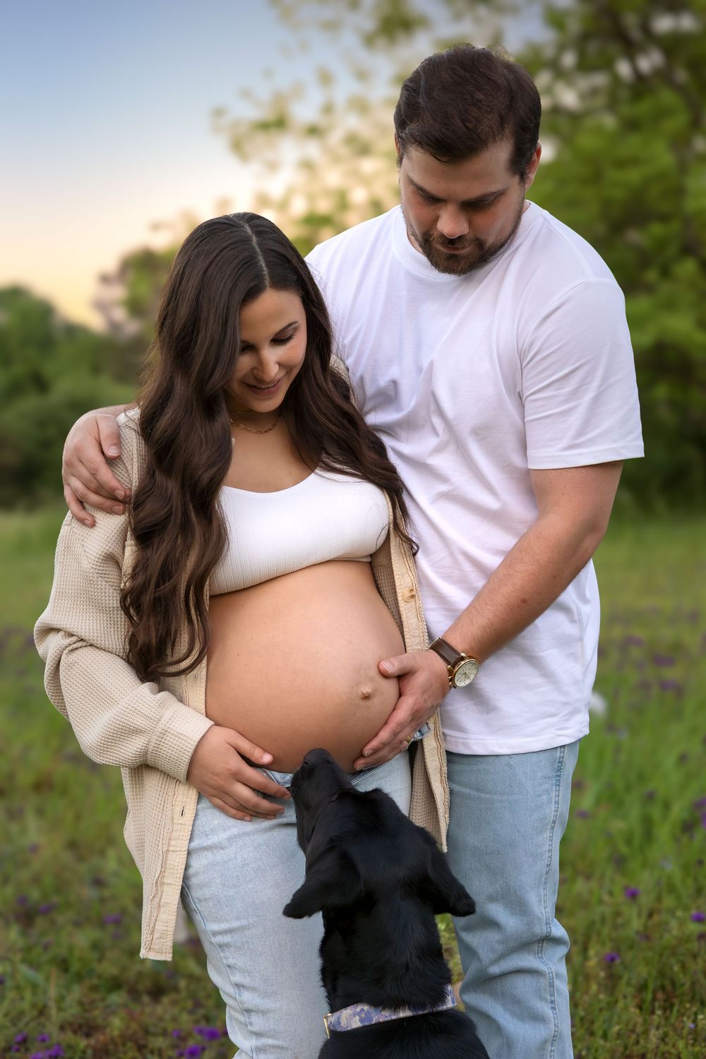 Maternity session with expecting couple and dog in wildflower field outside Athens Georgia