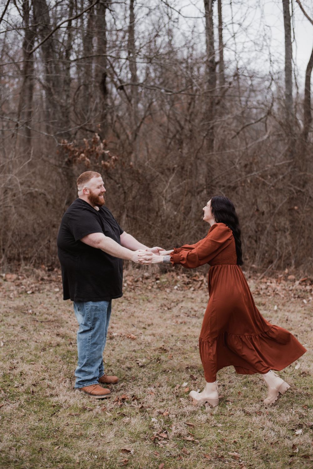A couple frolicking together in a field in Kentucky.