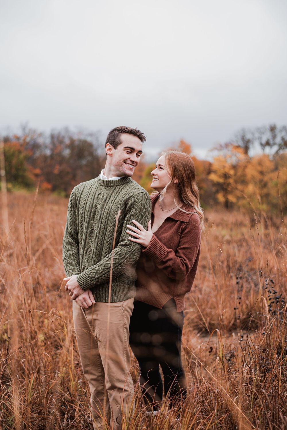 A couple in a field in the fall at French Park.