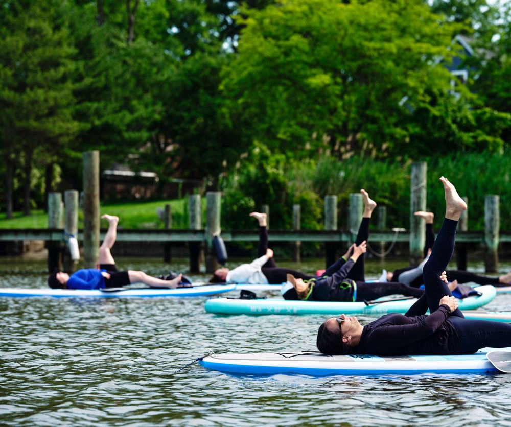 Aerial view of women doing paddleboard yoga on the Patapsco River. B'more SUP photography.