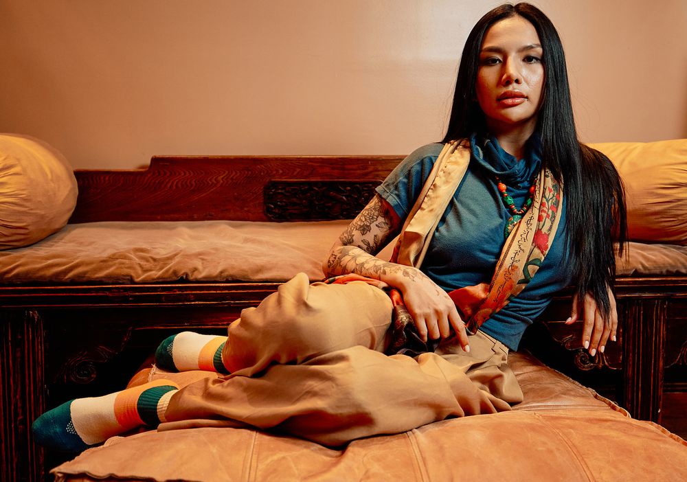Fashion photography of model posing on couch in modern Washington DC home.