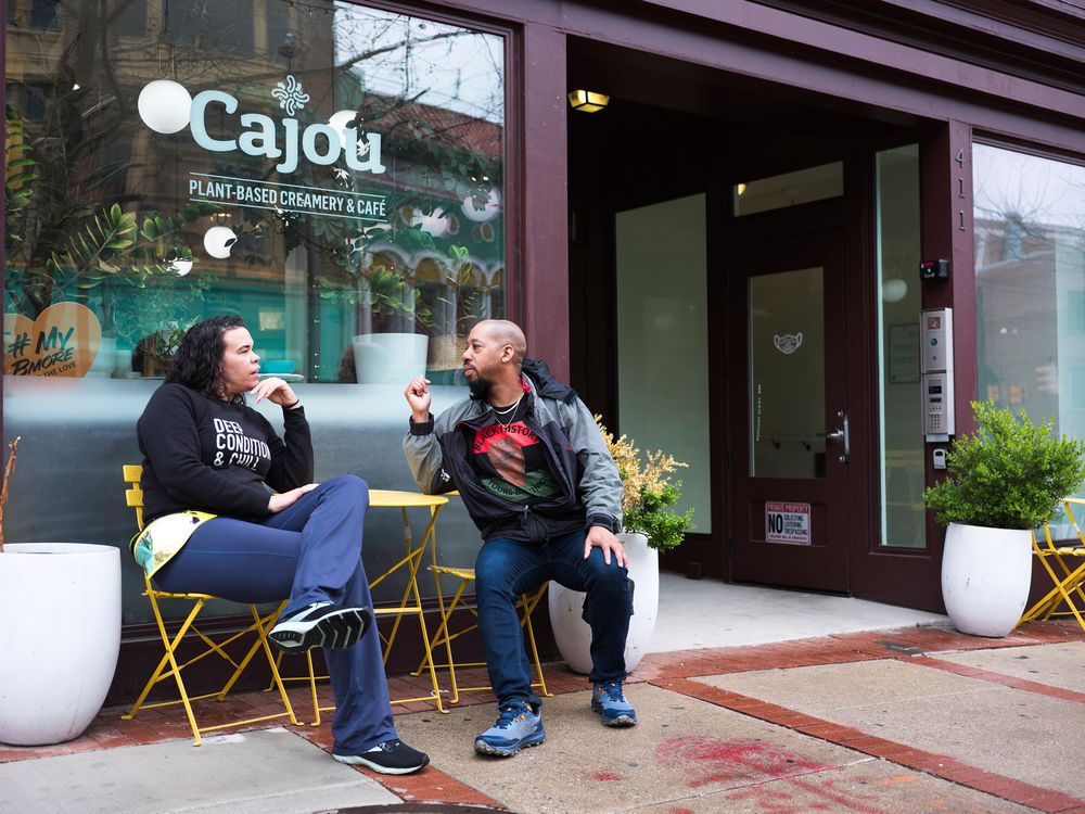 Lifestyle branding photo of couple drinking coffee outside a local Baltimore creamery.