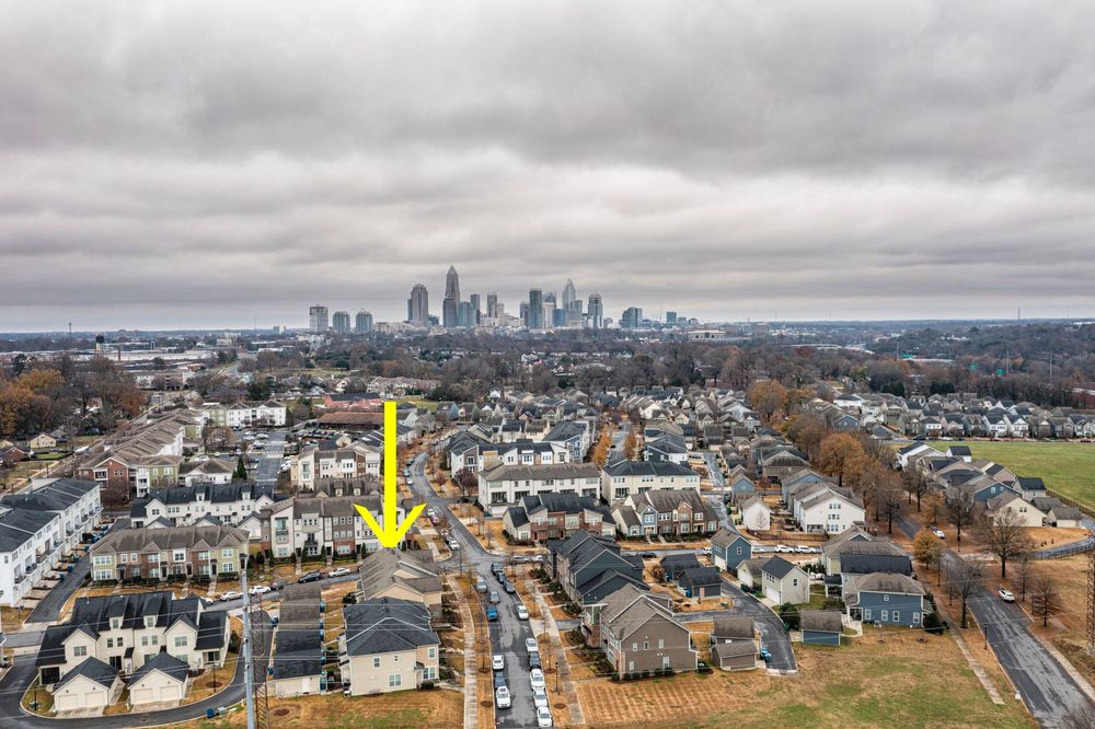 Panoramic skyline view of a city with residential developments in the foreground.