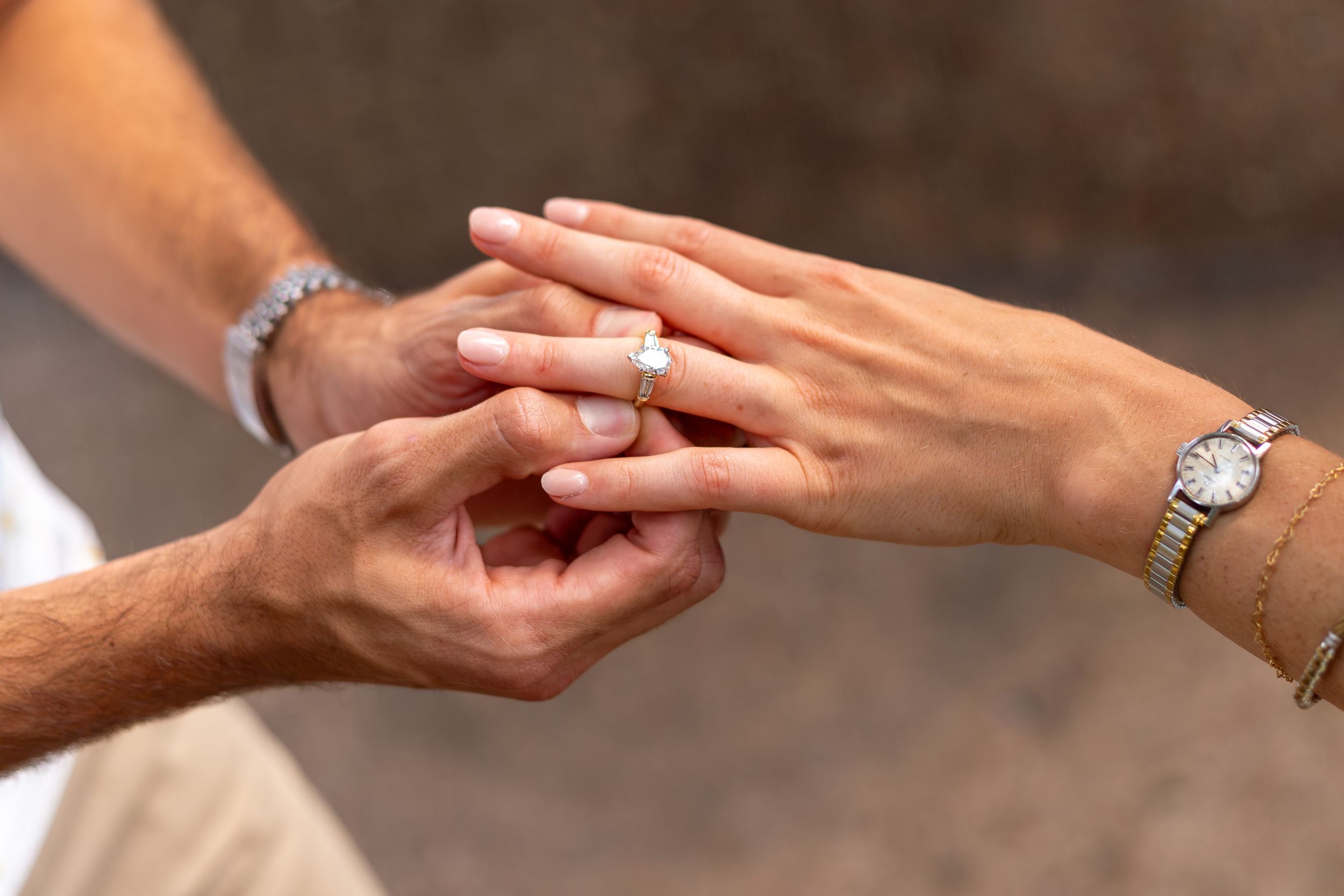 Close-up sequence of hands exchanging a diamond engagement ring during a romantic proposal moment. Fort Worth Dallas TX proposal Engagement