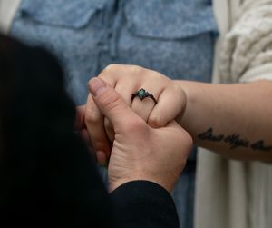Close-up of hands holding together in an intimate moment. proposal engagement session fort worth dallas texas