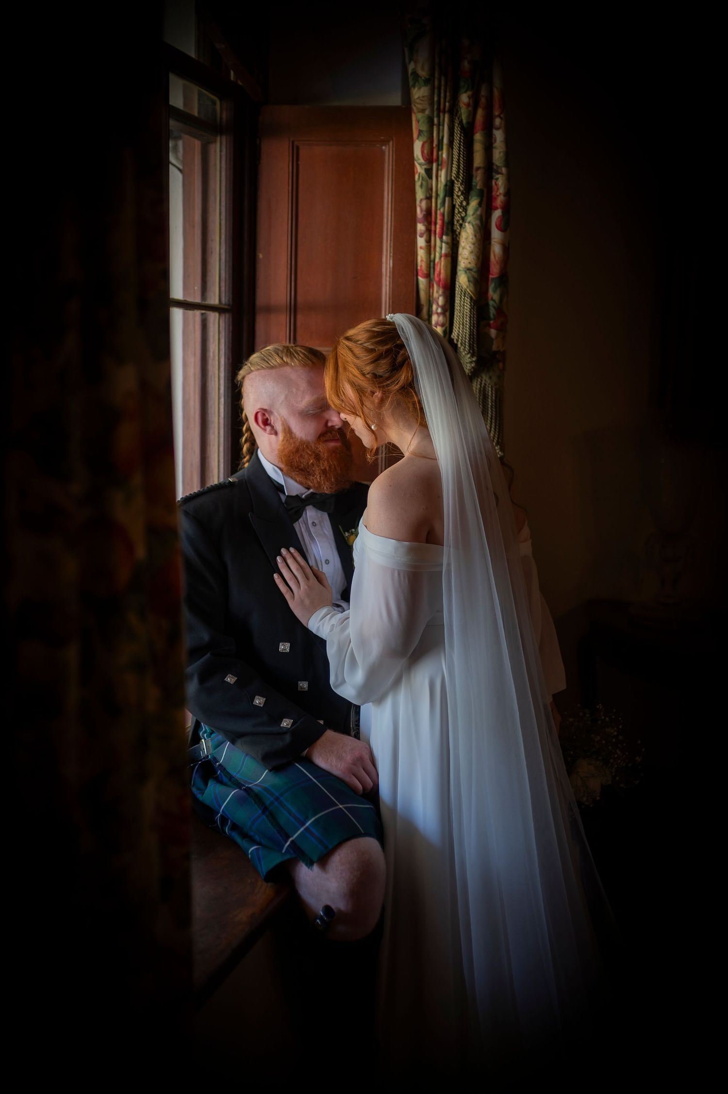 Romantic low-light portrait captures intimate moment in an indoor setting.