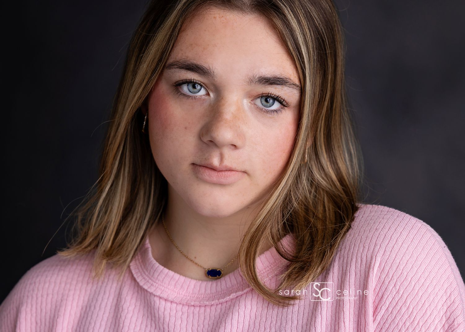 Studio portrait sequence showing someone in a pink sweater making different expressive poses against dark background.
