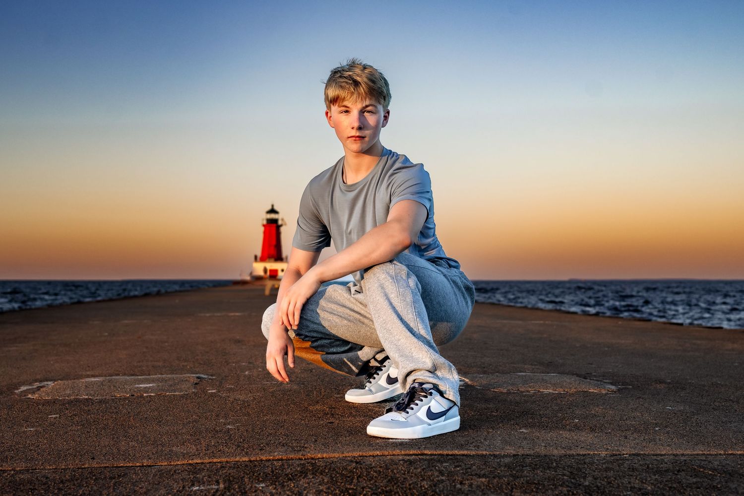 high school senior taking photos by Menominee Lighthouse