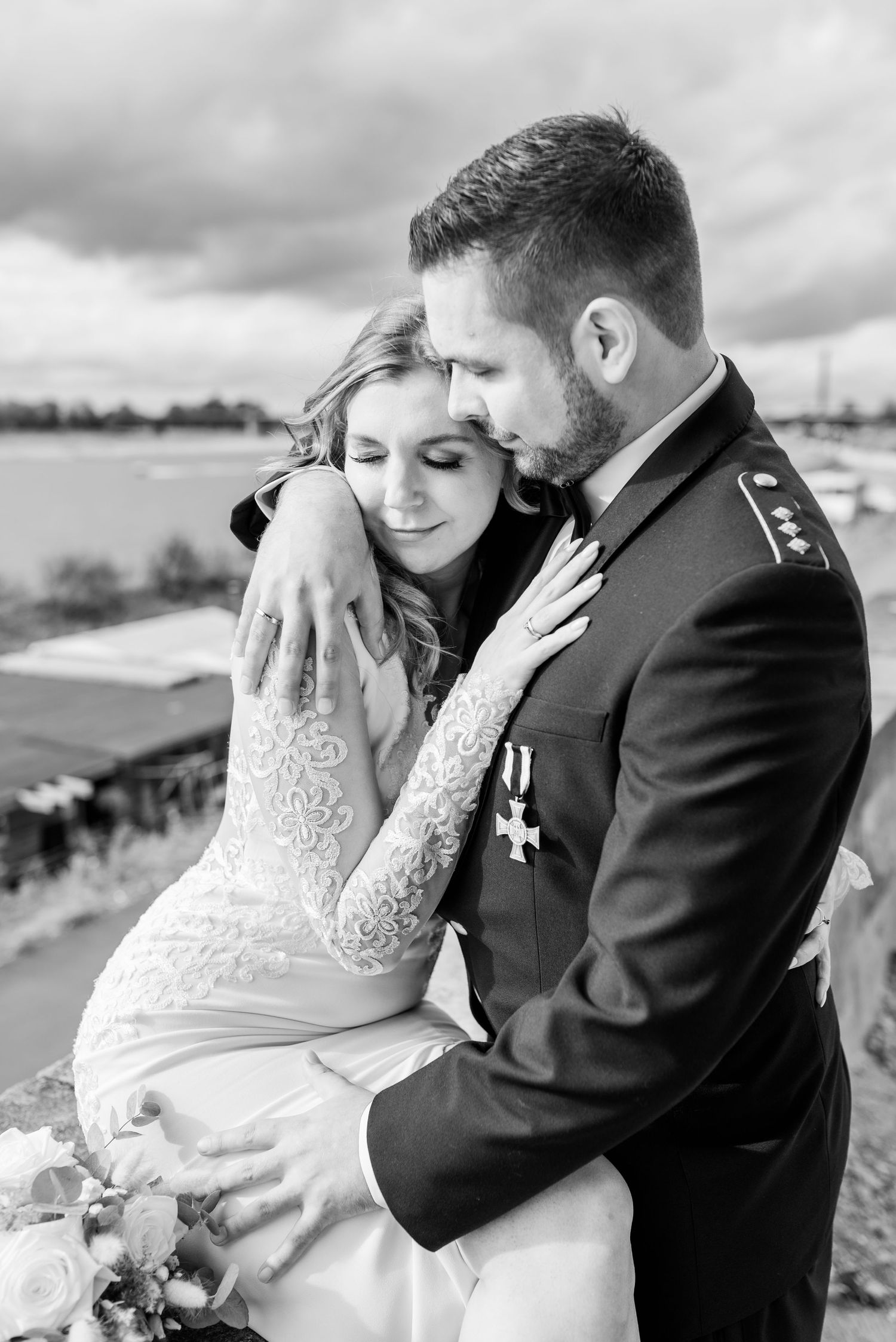 Military wedding portrait in black and white with lace dress details.