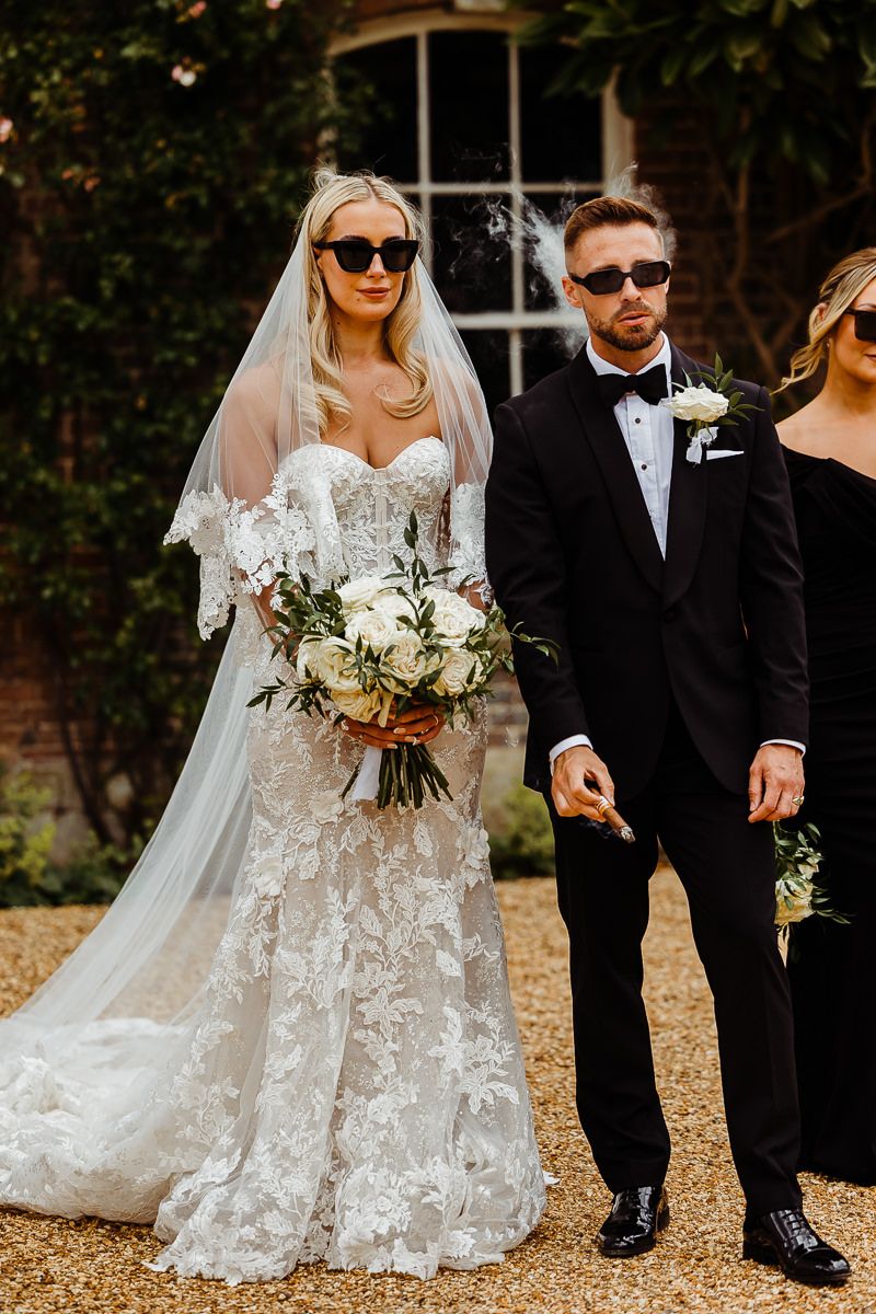 Stylish bride and groom with sunglasses syrencot