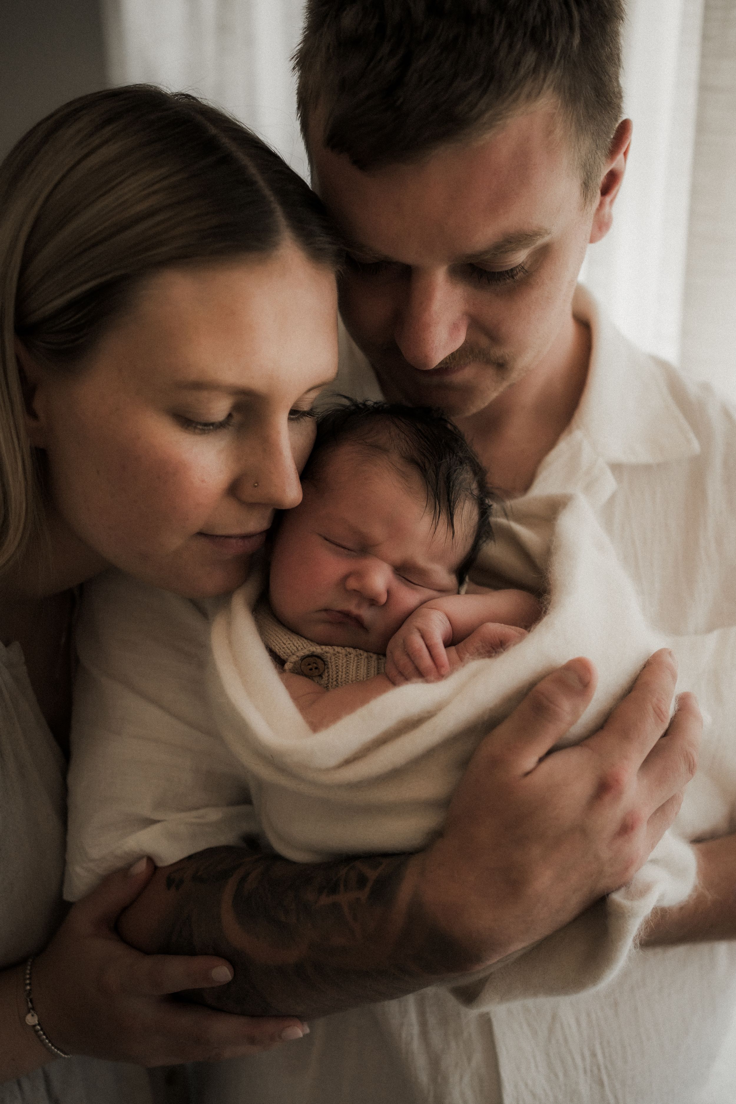 A tender black and white photo series showing intimate moments of affection and connection between a couple.