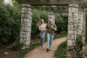 Playful moment of Skylar and Ben Skipping  at Loose Park’s rose garden path.