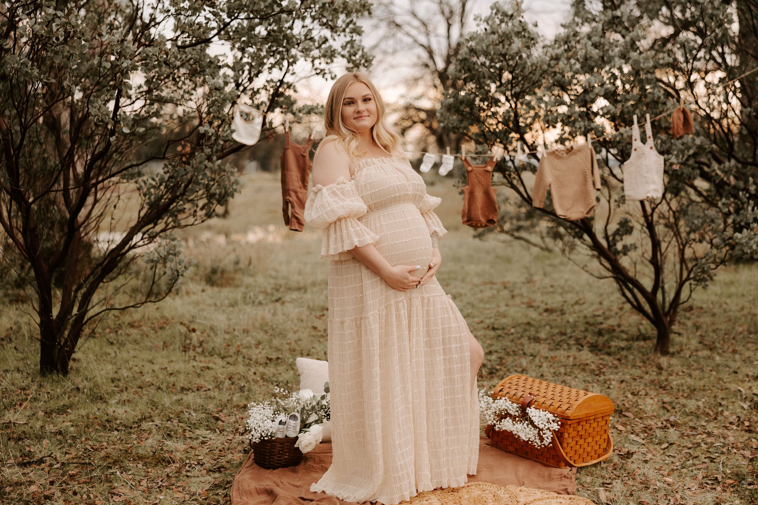 Rustic outdoor maternity session featuring vintage props and natural setting.