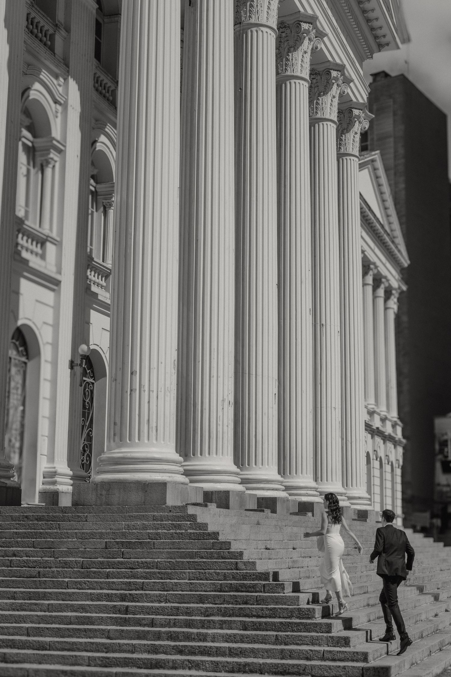 Classic black and white photograph of grand columns and steps at a historic building entrance.