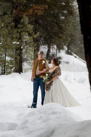 snowy winter elopement in Idaho City walking up the aisle together