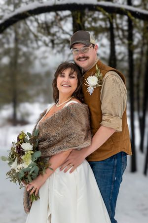 snowy winter elopement in Idaho City portrait of bride and groom